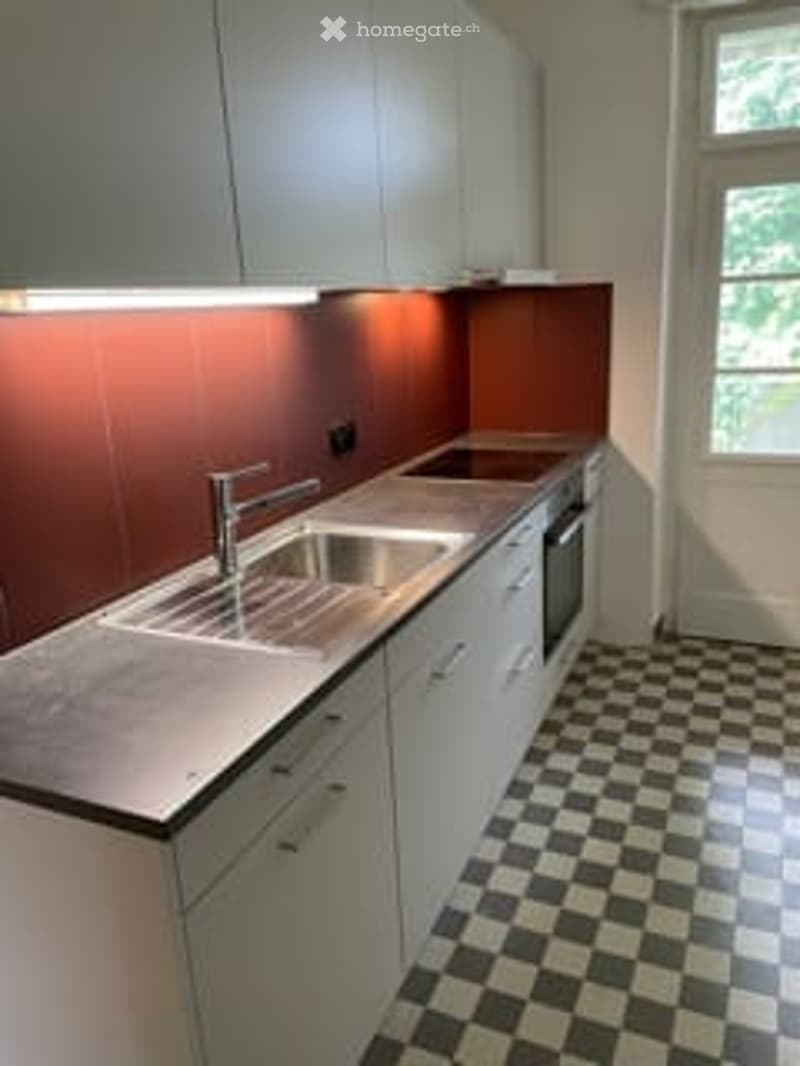 modern kitchen with white cabinets, stainless steel countertops, integrated sink, faucet, gas stove, dishwasher, tiled floor