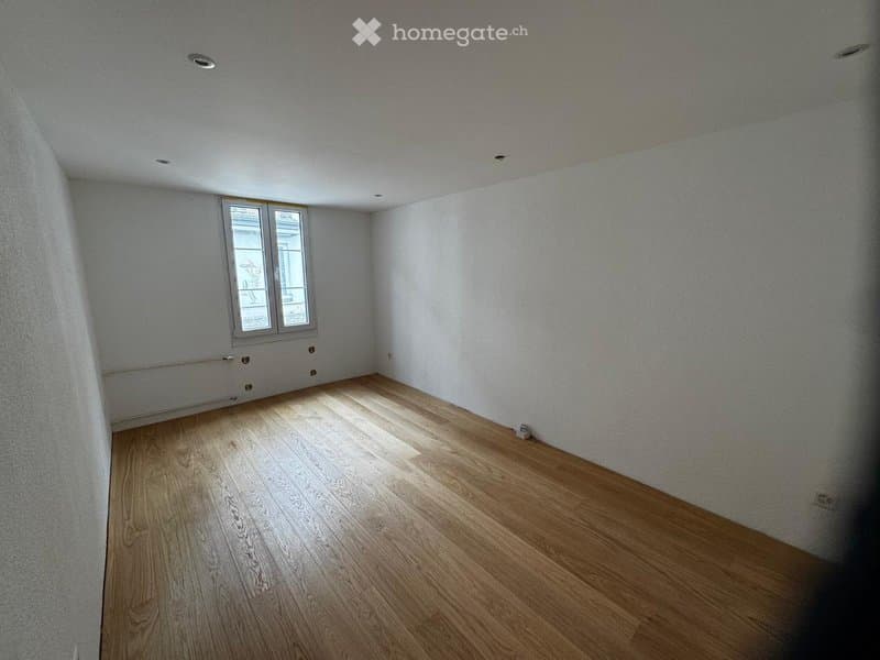 Completely empty room with bare walls and wooden floor. No furniture or equipment.