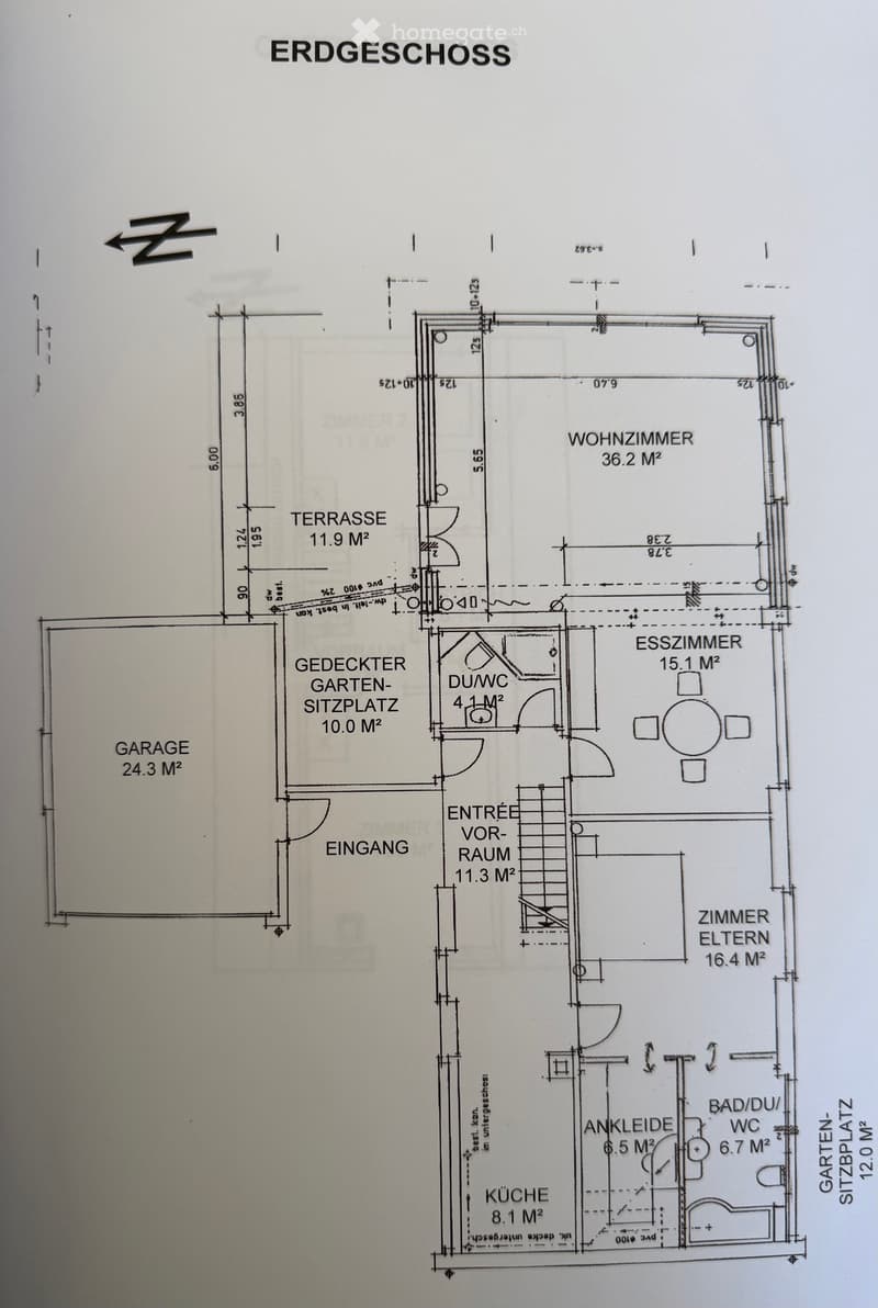 Ground floor plan showing living room, dining room, kitchen, bathroom, bedroom, covered garden seating area, terrace, and garage.