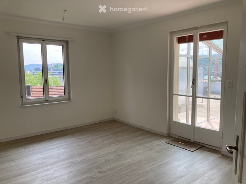 Other. {"visible_features":["Balcony / Terrace"],"type":"Living room","description":"Spacious living room with large windows, hardwood-style flooring, and a sliding glass door leading to a balcony or terrace with a view of the surrounding area."}
