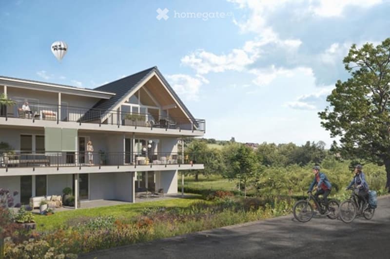 2 story house, white exterior, multiple balconies, garden, hot air balloon
