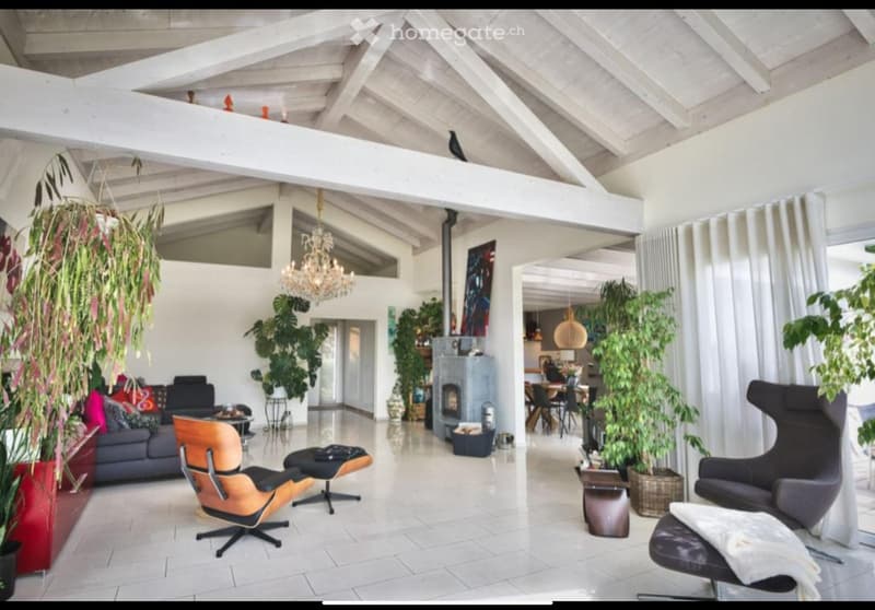 high ceilings, white tiles, chandelier, fireplace, lots of plants, couch, chairs, view
