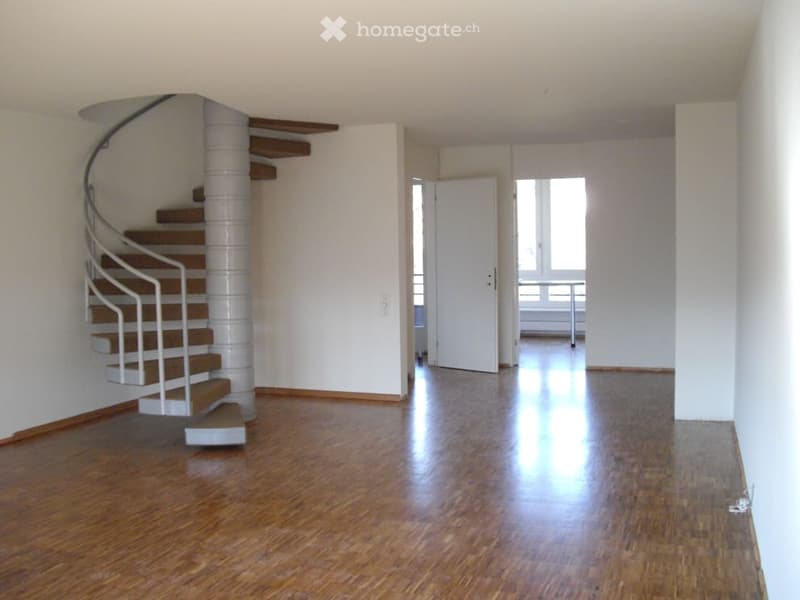 large open room, wooden floors, spiral staircase, white walls, open doorways