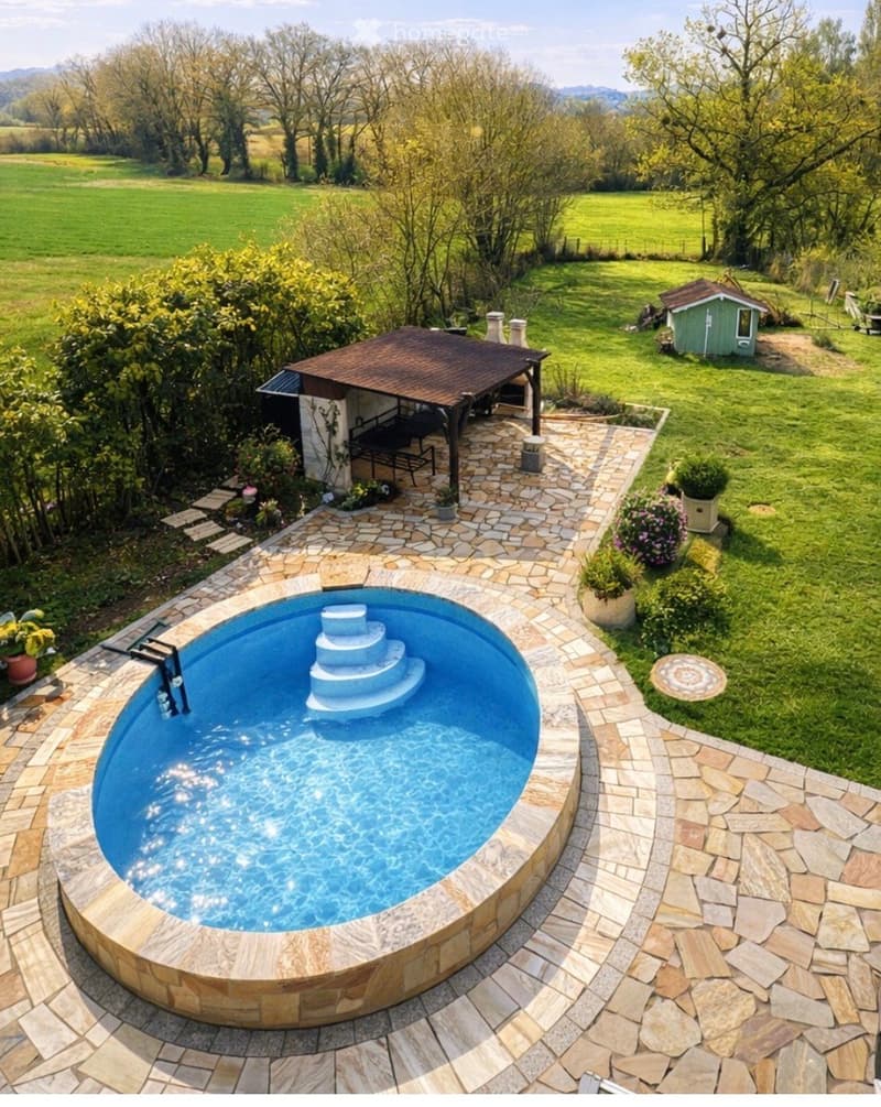 Outdoor garden area with a swimming pool, stone patio, small gazebo, and surrounding greenery.