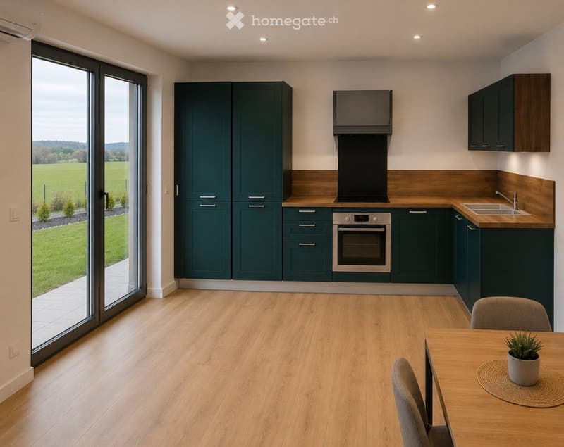 Modern kitchen with dark green cabinets, wooden countertops, built-in oven, sink, and a dining area with a table and chairs. Large sliding glass doors open to a green field view.
