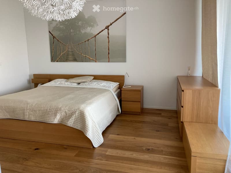 Wooden floor, king size bed, wooden nightstands, wooden dresser, large art piece on wall