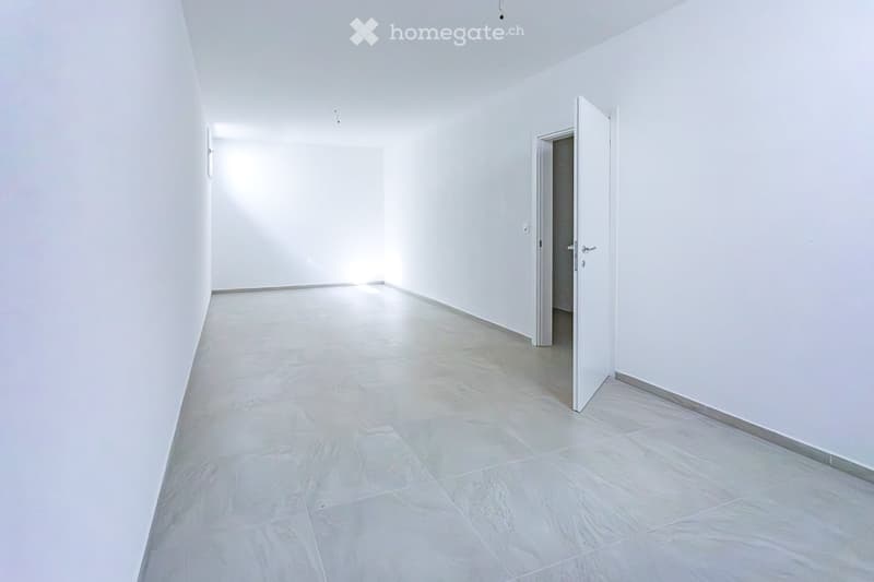 Empty room with white walls and light-colored tiled flooring. No furniture or equipment present.