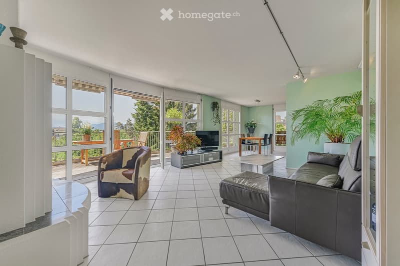 Modern living room with large windows, white tiled floor, leather sofa, coffee table, and dining area with table and chairs.