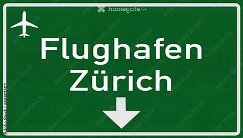 Green sign, white arrows and text 'Flughafen Zürich' and a plane symbol