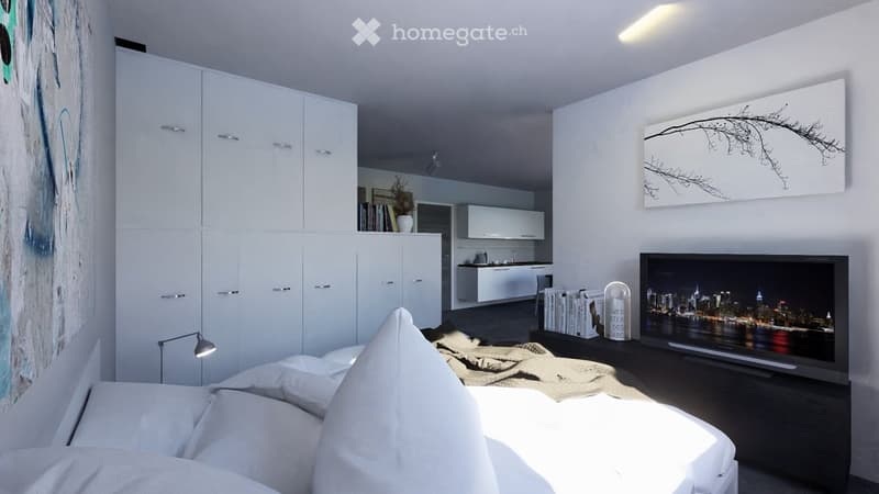 Contemporary bedroom with white walls, large bed, white bedding, white throw pillows, white cabinets, mounted art, TV on stand, illuminated lamp, dark flooring, view of open kitchen
