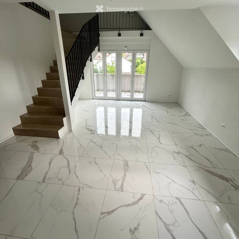Empty hallway with white marble flooring, a staircase with wooden steps and a black railing, and large glass doors leading outside.