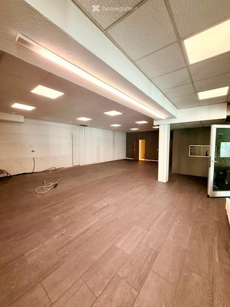 Completely empty room with bare walls and wooden floor. No furniture or equipment.