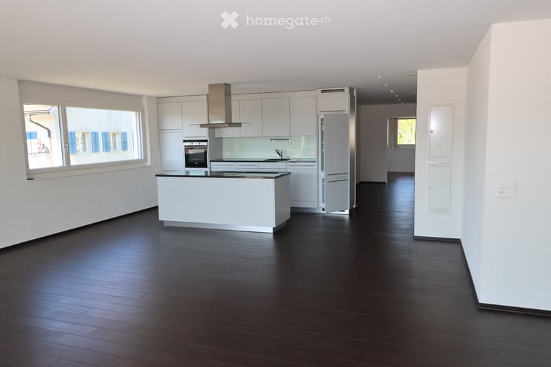 modern kitchen with white cabinets, black tiled floor, large window, built-in oven, refrigerator, kitchen island