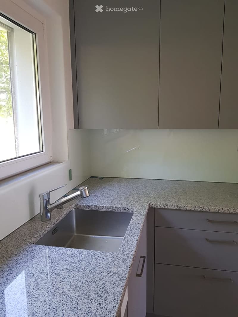 Kitchen. Modern kitchen with granite countertops, stainless steel sink, and sleek cabinetry.