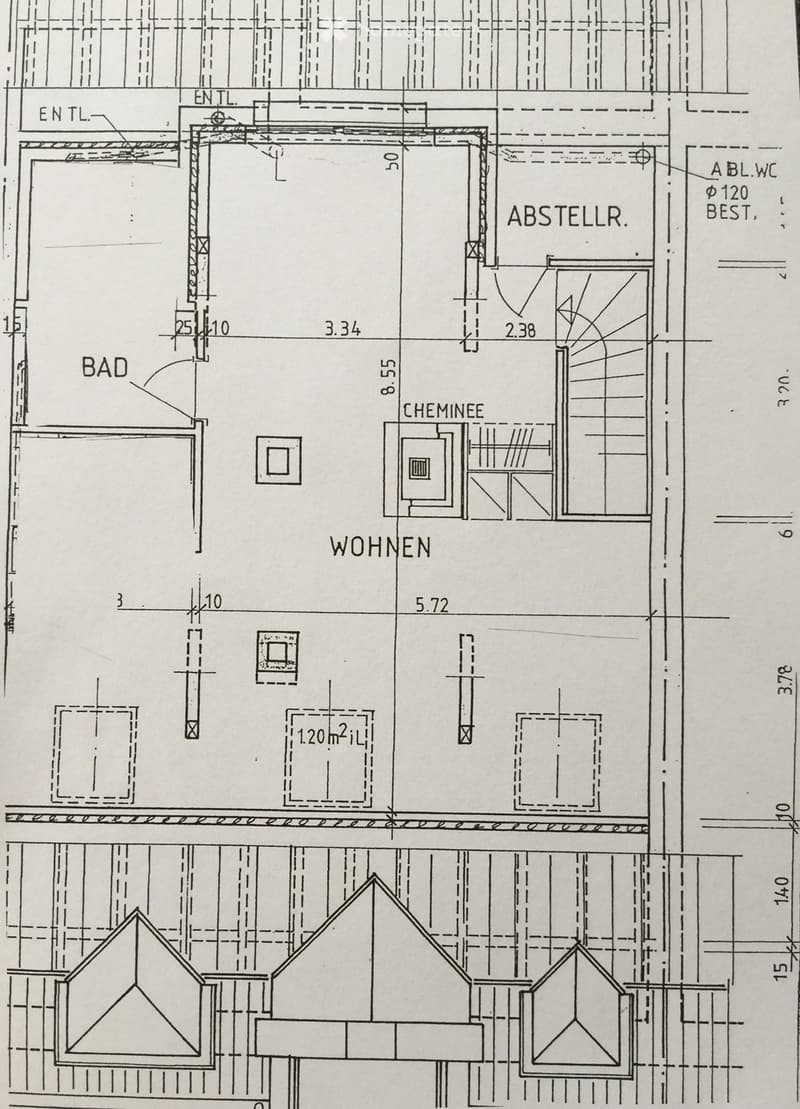 Floor plan showing a layout with labeled areas: bathroom (BAD), living area (WOHNEN), and a storage area (ABSTELLR.). Includes a fireplace (CHEMINEE) and measurements.