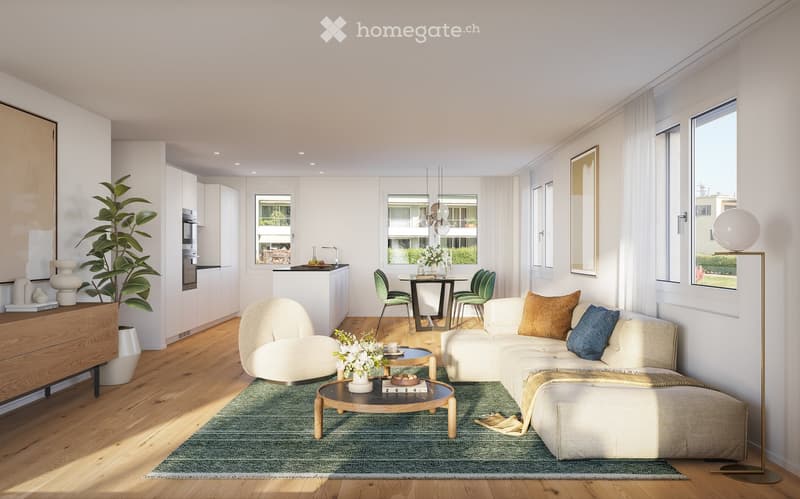 Modern living and dining area with light wood flooring, white walls, and large windows. Features a white sectional sofa with throw pillows, a round coffee table, an armchair, a floor lamp, a dining table with four chairs, and a kitchen island with cabinet