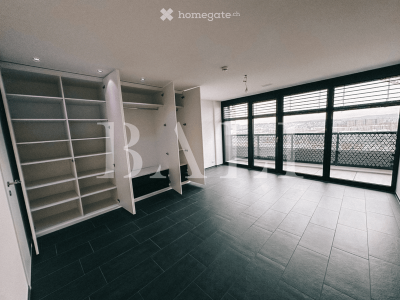 empty room, large windows, balcony, tiled floor, built-in wardrobes