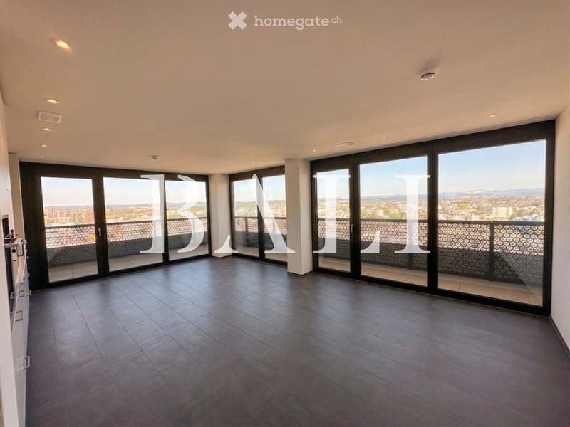Empty room with large sliding glass doors leading to a balcony, tiled floor, and recessed lighting.