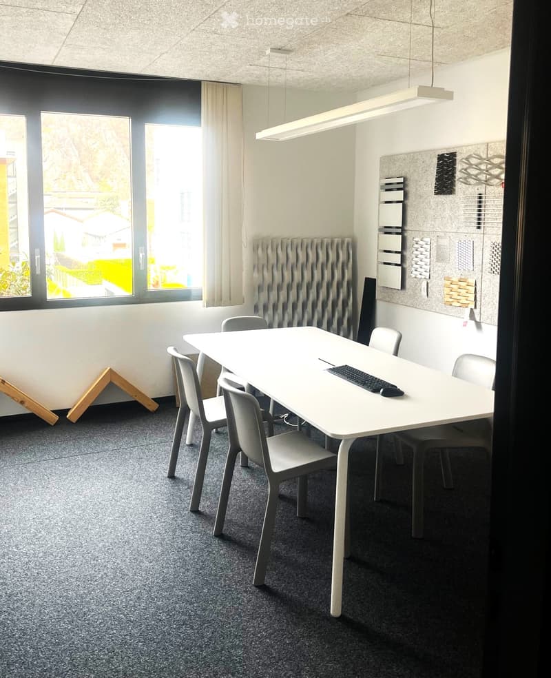 Modern office or meeting room with a white table, six chairs, a keyboard, radiator, and large windows with curtains.