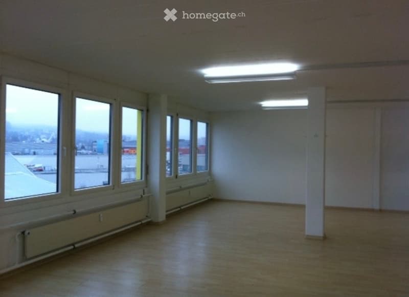 Unfurnished Room. Empty room with large windows, tiled floor, and fluorescent lighting. No furniture or equipment present.