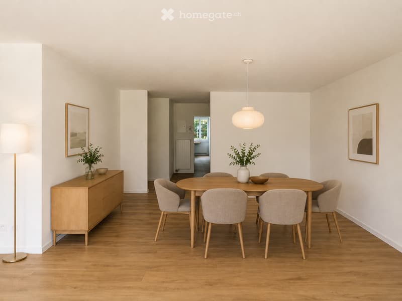 Dining room with a round wooden table surrounded by six chairs, a wooden sideboard with a vase and bowl, a floor lamp, and framed artwork on the walls.