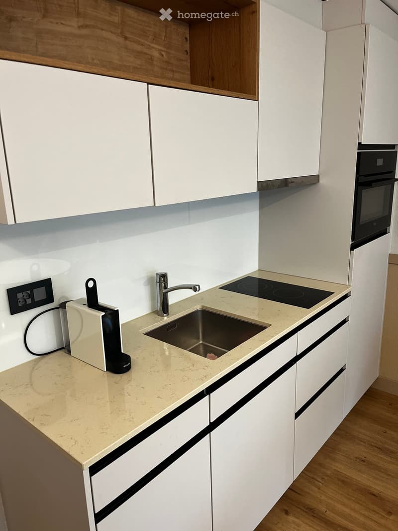 All white cabinets, beige countertop, under-cabinet lighting, electric stove, faucet, dishwasher, coffee maker