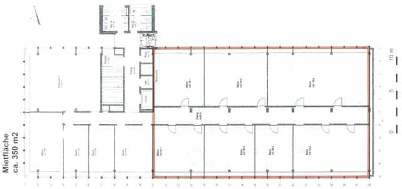 Floor plan of a commercial or industrial space with multiple rooms, including a large central hall, smaller rooms, and a separate entrance area.