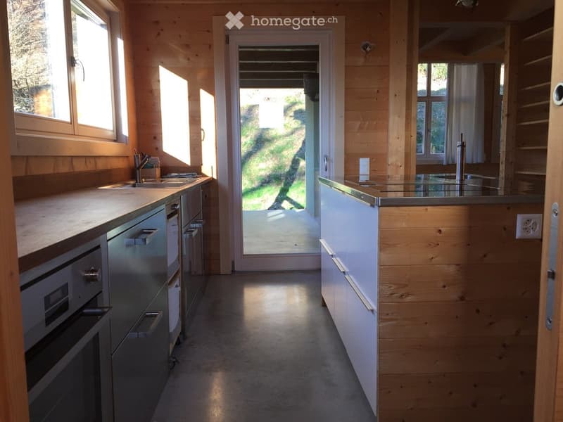 Kitchen with wooden cabinets, modern sink, and stainless steel appliances including a dishwasher and washing machine
