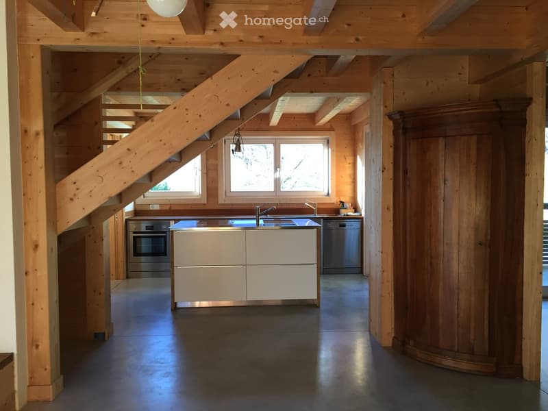 wooden interior, kitchen with white counters, stove, dishwasher, sink, open staircase