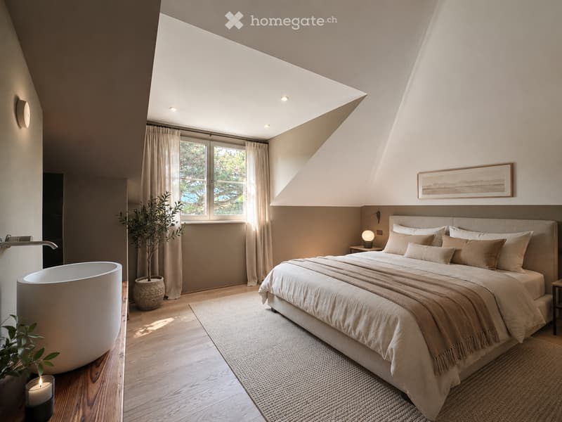 Modern bedroom with a large bed, nightstand, table lamp, bathtub, plant, and a view through large windows.