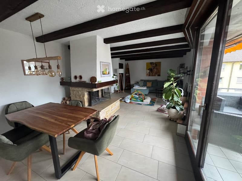 open space with living area, dining table, fireplace, tiles floor