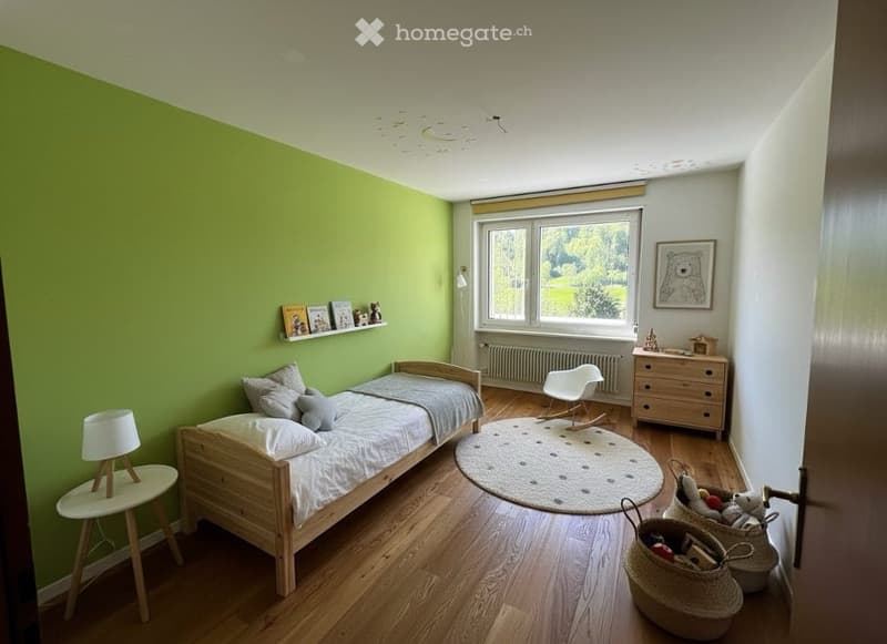 {"visible_features":[],"type":"Furnished Room","objects":["bed","lamp","side table","rug","chair","drawer","basket","basket","picture frame","books","stuffed toys","toys","pillow","pillow","pillow","pillow","pillow","pillow","pillow","pillow","pillow","pi