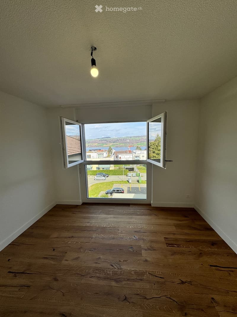 empty room, wooden floor, white walls, large windows, view of the outside