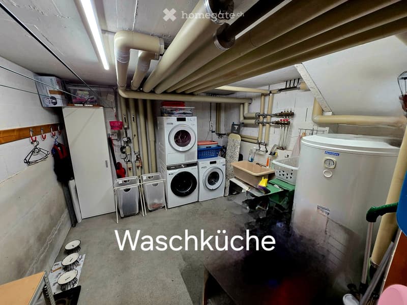 Bathroom. Utility room with washing machine, dryer, refrigerator, sink, and various storage items.