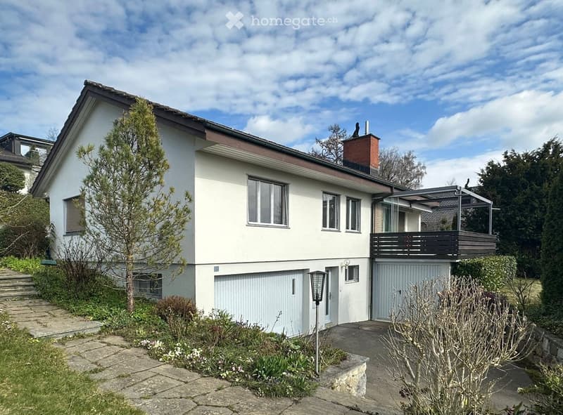 2 story house, white exterior, brown roof, 2 garages, balcony, chimney, steps leading to entrance