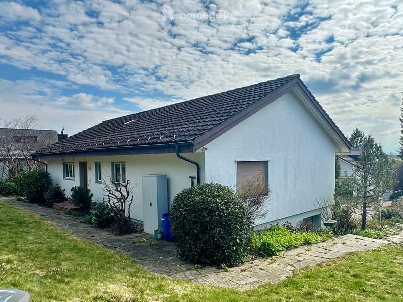 Single-family house, white exterior, brown roof, small garden, shrubs, pathway, blue barrels