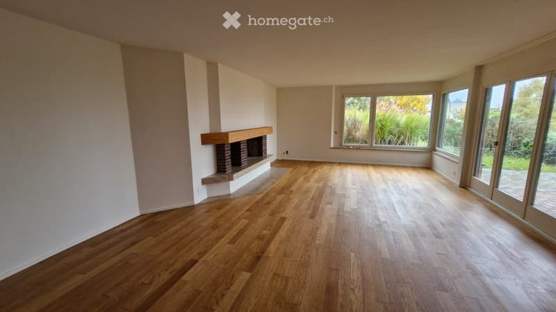 wooden floor, fireplace, white walls, large windows