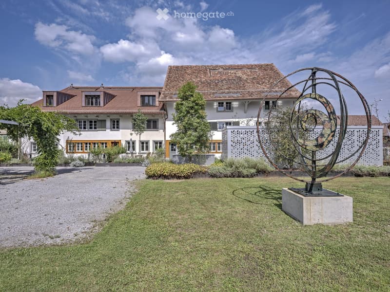 Two-story house, red tiles, yellow-framed windows, driveway, garden, artwork