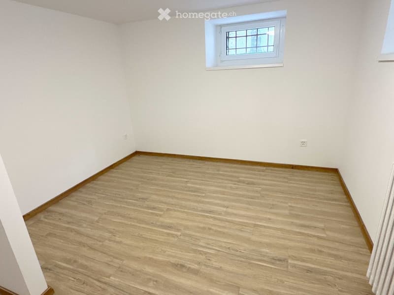 empty room, white walls, wooden floor, window, outlet