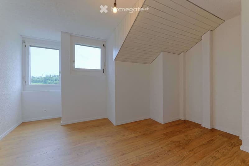 empty room, wooden floor, white walls, two windows, slanted ceiling