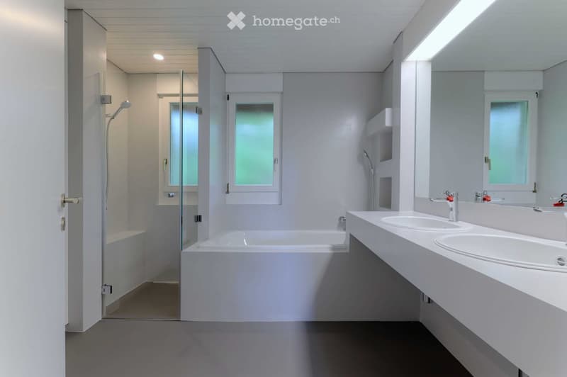 modern bathroom, white bathtub, two sinks, glass shower, white walls, white floor