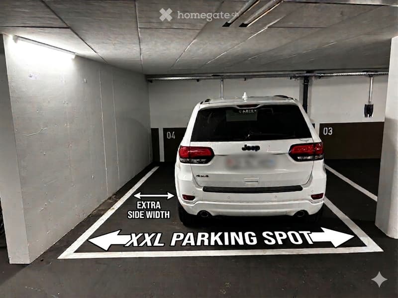 Underground parking area with a marked XXL parking spot, featuring a white Jeep parked inside.