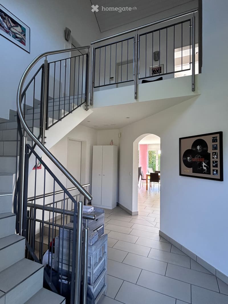 spiral staircase, white walls, tiled floor, white cabinet, framed picture, dining table, chairs, balcony