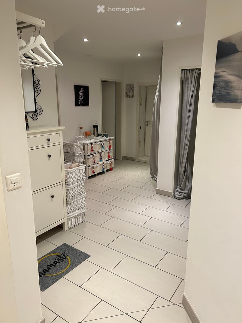 white tiled floor, white dresser, white baskets, white door, white walls, white ceiling, white light fixtures, white power outlet, gray rug, gray curtain