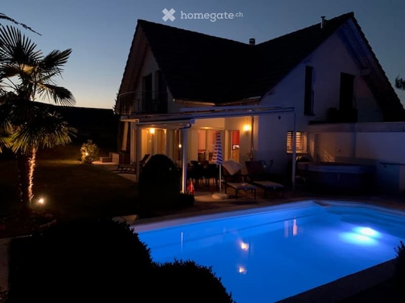 House with swimming pool, patio, and outdoor seating area
