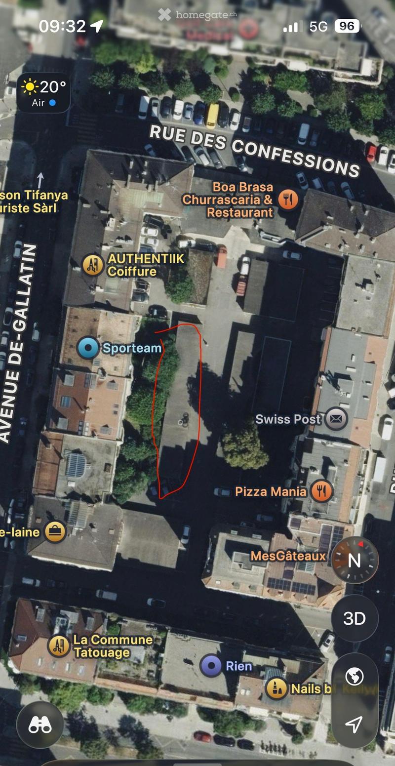 Aerial view of a residential area with multiple buildings, streets, and labeled businesses such as restaurants and shops.