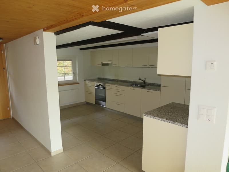 Bright kitchen with light-colored cabinets, granite countertops, and tiled flooring. Features an oven, sink, and faucet.