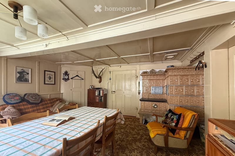 dining table, sofa, bookshelves, vintage lamps, fireplace, open door