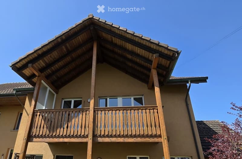 wooden balcony, brown roof, brown walls, glass windows