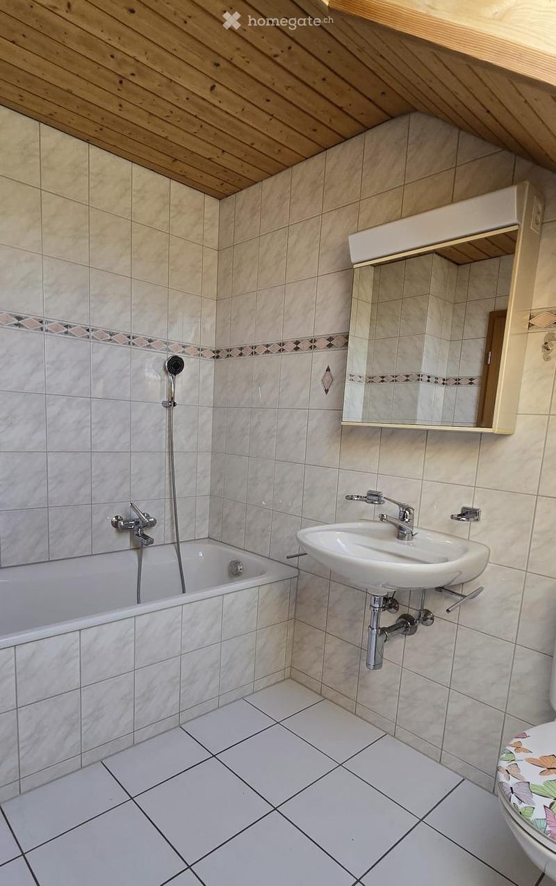 Bathroom with bathtub, sink, mirror, and toilet